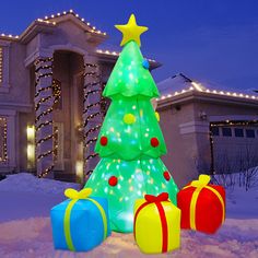 a christmas tree and presents in front of a house