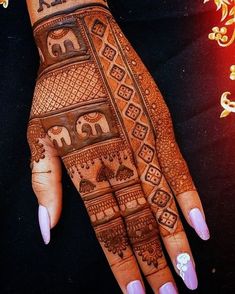 a woman's hand with henna tattoos on it