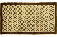 a brown and white rug with an intricate design