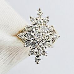 a diamond ring sitting on top of a white cloth