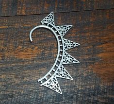 This silver spike ear cuff is lightweight and adjustable to fit any ear! Great for festive outfits and festive people :) We found this piece while traveling across the tribal deserts in India. Indian tribal jewelry is known for being unique, detailed and high quality. It hangs loosely on the top, but stays on even through festivals and parties. The top piece is adjustable to hug even the smallest of ears. It is double sided and can be worn on either ear. This ear cuff is made from triple silver Spike Ear Cuff, Festive Outfits, Gold Elephant, Wrap Earrings, Feather Wings, Silver Ear Cuff, Tiger Eye Bracelet, Punk Jewelry, Arm Cuff