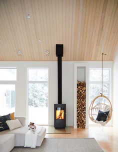 a living room filled with furniture and a fire place in the middle of it's walls