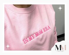 Professionally embroidered IN MY MOM ERA crewneck sweatshirt.  Small text across the chest in a hot pink thread to contrast the pink sweatshirt. These are embroidered on unisex crewneck sweatshirts  UNISEX FIT  SHORT SLEEVE 100% RINGSPUN COTTON Want a different color? Checkout our shop for other color options!  Want a different word? Just message us & we will let you know if we can! Pink Custom Embroidery Sweatshirt For Streetwear, Trendy Embroidered Pink Sweatshirt, Trendy Pink Sweatshirt With Embroidered Graphics, Pink Trendy Sweatshirt With Embroidered Logo, Trendy Pink Sweatshirt With Embroidered Logo, Pink Crew Neck Sweatshirt For Mother's Day, Relaxed Fit Pink Sweatshirt With Embroidered Graphics, Pink Embroidered Sweatshirt With Relaxed Fit, Pink Relaxed Fit Sweatshirt For Mother's Day