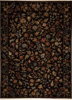 a black rug with flowers and leaves on the bottom, in an ornate frame around it