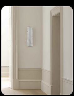 an empty room with a white radiator on the wall