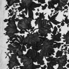 black and white photograph of flowers on fabric