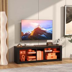 a flat screen tv sitting on top of a wooden entertainment center in a living room