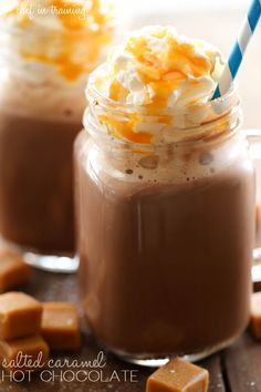 two glasses filled with hot chocolate and whipped cream