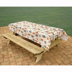 a wooden bench with a table cloth on it