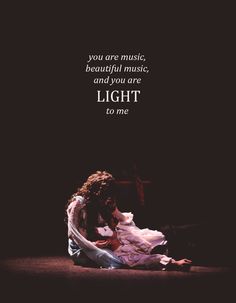 a woman sitting on the ground with a quote above her that reads, you are music, beautiful music, and you are light to me