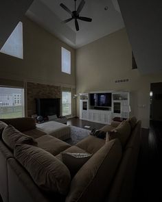 a living room filled with furniture and a flat screen tv mounted to the wall in front of a fireplace