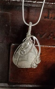 Gray & White triangle shaped agate.  Stone is wrapped in 925 Sterling Silver and pendant is on an 18 inch 925 Sterling Silver chain. 925 Sterling Silver Chain, Triangle Shape, Wrapped Jewelry, Agate Stone, Wire Wrapped Jewelry, Sterling Silver Chain, Wire Wrapping, Wire Wrapped, Gray White