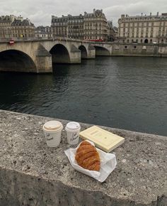 coffee and croissants on the edge of a bridge