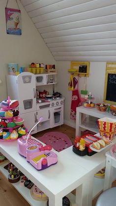 a play kitchen with lots of food on the table