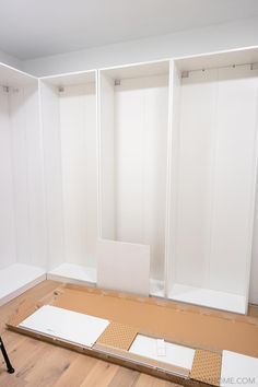 an empty room with white walls and wooden flooring is being built into the wall