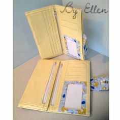 two yellow folders with writing on them sitting next to each other, one opened and the other closed