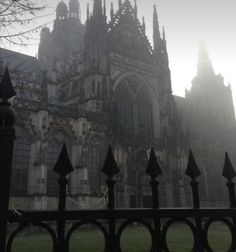 an old building with many spires in the fog