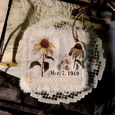 a white doily with flowers on it and the date march 2, 1909 written in black