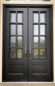 two black double doors with sidelights and windows