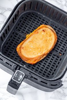 a toasted sandwich sitting on top of a black grill