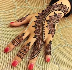 henna tattoo designs for hands and feet with pink ribbon on the bottom of her hand