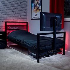 a bedroom with a bed, television and red lights on the brick wall behind it