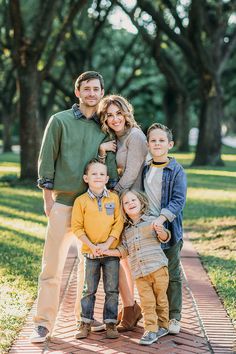 a family posing for a photo in the park