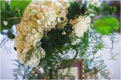 a vase filled with white flowers on top of a table