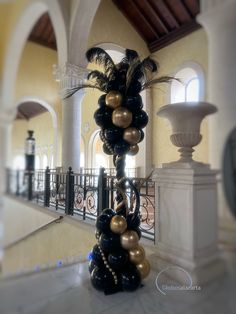 black and gold balloons are on display in the lobby