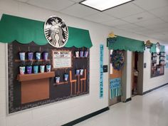 there is a starbucks sign on the wall in this school hallway that has been decorated