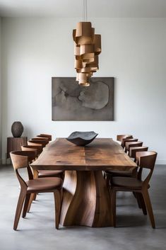 a wooden table with chairs around it and a painting on the wall in the background