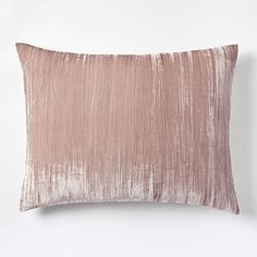 a pink pillow on a white wall