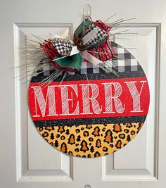 a christmas ornament hanging on a door with the word merry in red and black