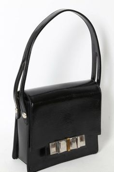 Vintage Black Snake Embossed Leather Bow Handbag Purse Bag is Pre-owned, Good Condition Scratches on hardware. Light wear on sides Snap closure Black color Leather body Silver tone hardware Interior features: one zipper & one slide pockets Brand: Unbranded Material: Leather Measurements in Inches: * Length across: 7.75 * Height: 7 * Bottom wide: 2.5 * Leather handles drop: 6 Leather Satchel Box Bag With Silver-tone Hardware, Vintage Rectangular Bag With Branded Hardware, Formal Handheld Satchel With Silver-tone Hardware, Formal Handheld Shoulder Bag With Branded Hardware, Leather Evening Bag With Top Handle And Metal Hardware, Formal Shoulder Box Bag With Branded Hardware, Black Leather Box Bag With Palladium Hardware, Vintage Formal Shoulder Bag With Branded Hardware, Evening Satchel Bag With Metal Hardware