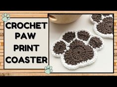 crochet paw print coasters are shown on a table with the words crochet paw print coaster