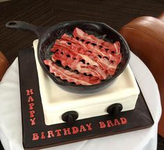 a birthday cake with bacon in a frying pan