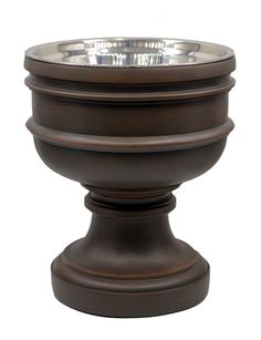 a large metal bowl sitting on top of a wooden stand