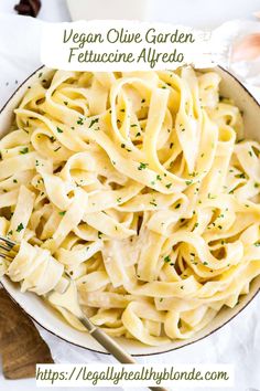 a bowl filled with pasta and garnished with parsley