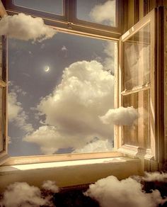 an open window with the sky and clouds reflected in it