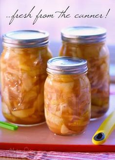 three jars filled with food sitting on top of a table