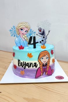 a frozen princess themed birthday cake with the number four on it, and two cartoon characters