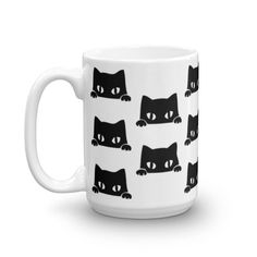 a white coffee mug with black cats on the front and bottom, all over it