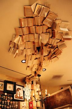 a room filled with lots of books floating from the ceiling