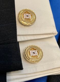 This is a beautiful pair of cufflinks with lots of gorgeous detail. First the gold tone is very bright and shiny. There is diamond cutting around the edge. In the center is a raised wreath of leaves like the olive leaves worn on the heads of ancient Romans. In the very center is a white enamel rectangle with oriental looking designs. What does all this detail mean? We have no idea; we only know that these are good looking cufflinks. Though unsigned, they have been made with quality. We will send Olive Leaves, Eagle Necklace, Dollar Gift, Silver Gift Box, Porcelain Roses, Hammered Gold, Olive Leaf, Ancient Romans, Gold Texture