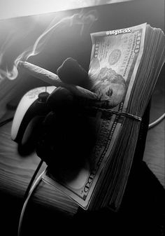 a stack of money sitting on top of a desk