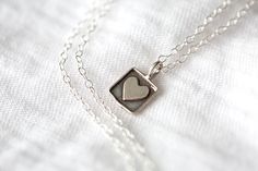 An antiqued silver heart in a square frame. Pendant is 10mm, Sterling Silver. Dainty Sterling Silver Cable Chain is 2x1.3mm -PRESENTATION & GIFTING- All of our jewelry comes beautifully wrapped in a hand stamped kraft jewelry box with a bow; ready for gifting! Just leave a note and I will include a personalized message for your gift recipient. Every piece of jewelry comes with a free cleaning cloth! -ABOUT US- We've been selling here on Etsy for many years; you're getting amazing quality jewelry Valentine's Day Sterling Silver Heart Necklace Keepsake, Gift 925 Stamped Heart-shaped Necklace, Valentines Day Necklace, Sterling Silver Nickel-free Heart Necklace For Valentine's Day, Valentine's Day Silver Heart-cut Necklace, Heart-shaped Stainless Steel Keepsake Necklaces, Heart Necklace Silver, Necklace For Mom, Silver Heart Necklace