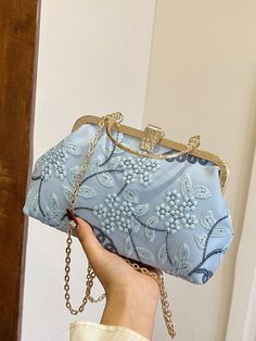 Expertly crafted with delicate blue lace embroidery, this elegant handbag is the perfect accessory for any special occasion. Its sophisticated design and high-quality materials exude a sense of luxury and style. With enough space to hold all your essentials, this handbag is both functional and fashionable. Light Blue Formal Shoulder Bag, Elegant Blue Shoulder Bag Clutch, Elegant Embroidered Handheld Evening Bag, Elegant Embroidered Handheld Shoulder Bag, Elegant Handheld Embroidered Shoulder Bag, Elegant Blue Handheld Clutch, Blue Rectangular Shoulder Bag For Events, Elegant Blue Bags As Gifts, Elegant Blue Bags For Gifts