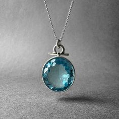 "Pure Clean High Grade Blue Swiss Topaz Ring - Spectacular Big Topaz Pendant - Father's Special Collection Piece - Completely Handmade & Silver Gemstone: Natural White Topaz Metal: Pure and 925 Sterling Silver Stone Cut: Faced Stone Size: 20.9 mm x 19.0 mm - 0.82 in x 0.74 in Pendant Size: 32.6 mm x 20.7 mm - 1.28 in x 0.81 in Stone Weight: 7.7 grams (38.5 carats) Weight: 13.1 grams (65.5 carats) total weight of stone and metal.  For ring orders, ring resizing is free.  Chains are gifts for necklace orders. Note: We don't use any filters for photos. The details may not be clear. Feel free to contact us with any questions, special orders or additional photo or video requests. We will be happy to provide more information! :) WORLDWIDE FedEx, UPS or TNT EXPRESS MAIL SERVICE (Delivery time: 1 Aquamarine Round Pendant Gemstone Jewelry, Round Turquoise Aquamarine Necklace, Turquoise Aquamarine Round Necklace, Turquoise Aquamarine Necklace, Aquamarine Gemstone Round Pendant Necklace, Round Light Blue Topaz Necklace, Blue Round Faceted Jewelry, Blue Faceted Round Jewelry, Turquoise Blue Topaz Pendant Jewelry