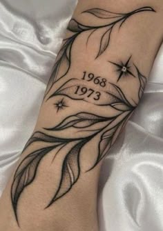 a woman's foot with a tattoo on it and the date in black ink