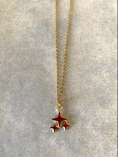 "Dainty, attractive and unique gold tone and red polar stars necklace. Pendant is small measuring 1/2\" L X 1/2\" W and is on an 18\" chain. ★ Want to see more? Please visit my shop at: https://www.etsy.com/shop/DesignsByPeg" Red Star Necklace, Gold Star Jewelry, Star Jewellery, Red Pendant Necklace, Stars Jewelry, Gold Star Pendant, Stars Necklace, Cool Jewelry, Red Stars